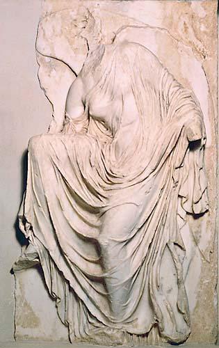 Nike Adjusting Her Sandal At one time the temple was surrounded by a parapet, or low wall, with sculpted marble panels depicting Athena presiding over her winged attendants called, Victories.