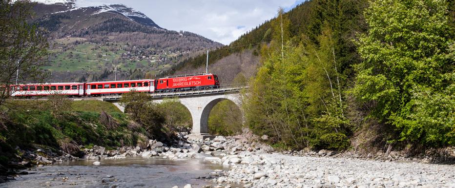 The train continues through the fertile Rhone Valley to Visp, from where travellers may make the excursion trip to Brig focal point of the Upper Valais at the foot of the Simplon Pass and