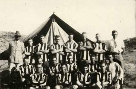 John (standing to the far right) with a football team.