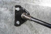 Use 6mm bolts, washers and split rings to fix the gas strut to the trailer wall.