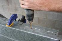 Cut the hinge with a metal saw or angle grinder to the desired length.