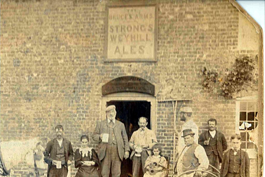 A55. George Allen (in doorway, right) wife Annie (left of doorway) da. Eleanor (seated) at the Bruce's Arms, Wilts c.1901.