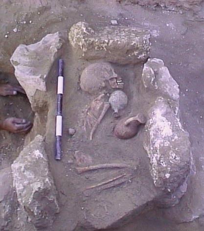 3) was placed in a re-used constructed mud brick grave and the disarticulated bones from the earlier burial 51 were pushed to one side.