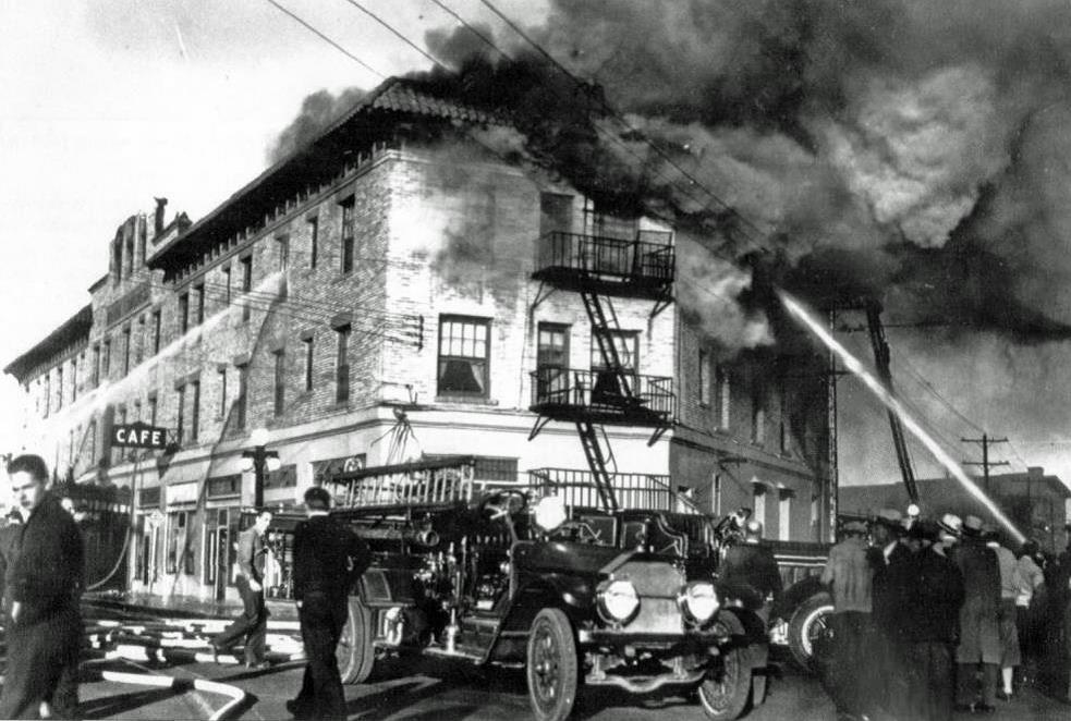 Firefighters at the corner of Congress Street and Toole Avenue pour water into the third floor of the Hotel Congress.