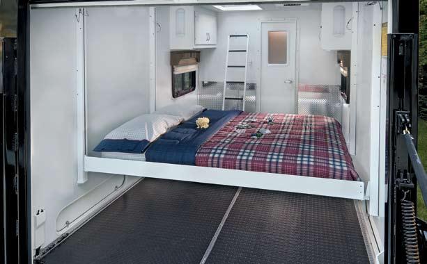 New queen-size electric drop-down bed in cargo area. There is an electric control that allows you to raise the bed when not in use. The electric drop-down bed in the cargo area is a new feature.