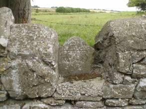 " built into boundary wall to west of the church, looking northeast The graveyard is located in a rural area in gently undulating pasture, south of the M7 and directly east of a farm complex.