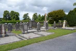 headstones on the western side of the burial ground, looking northwest The burial ground lies in the town of Abbeyleix and surrounds the 19th century church.