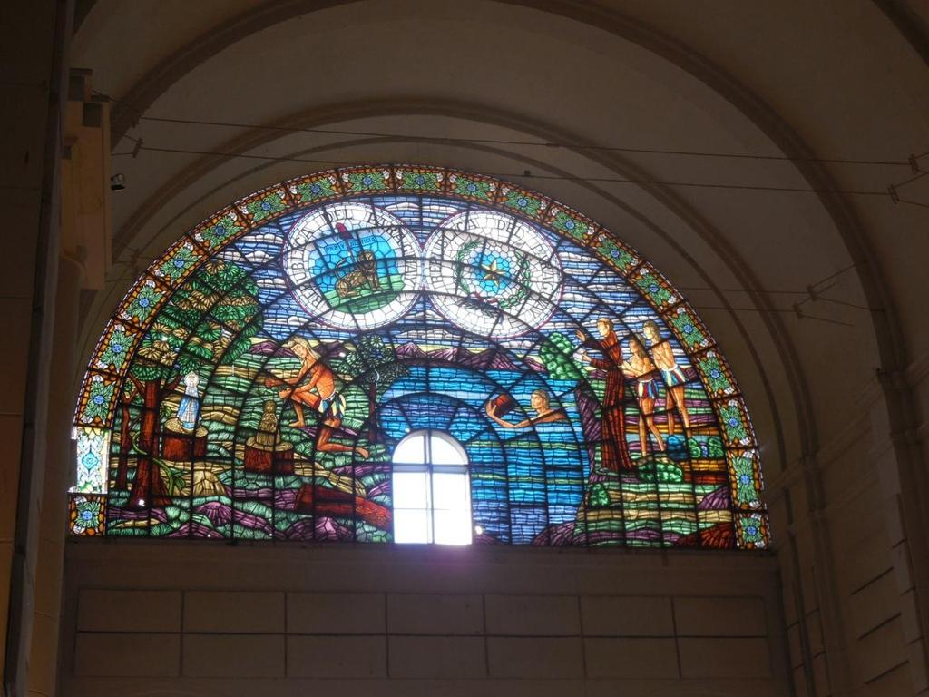 When I finally turned to leave the basilica, I noticed a large stained-glass mural in the back of the