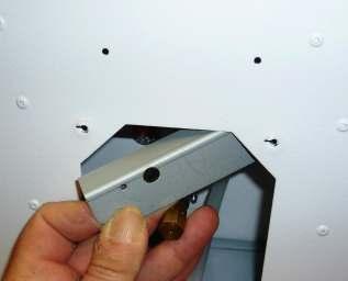 towards the holes at the front of the burner box. For VC burners there will already be 2 screws located in these holes.