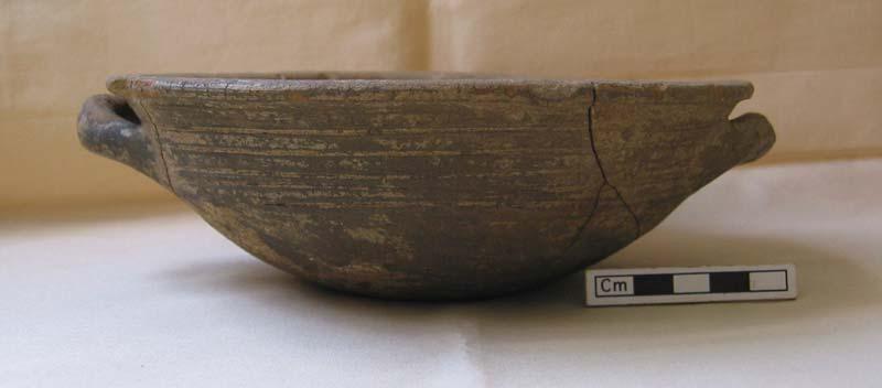 Fig. 6.4 Artifact 2424, an indigenous grayware bowl with incised decoration, from layer C1.24 in room C1/1. Diameter 18 cm, height 6 cm, c. 575 BC. Restoration Anne Haabu, photo Emma Blake.