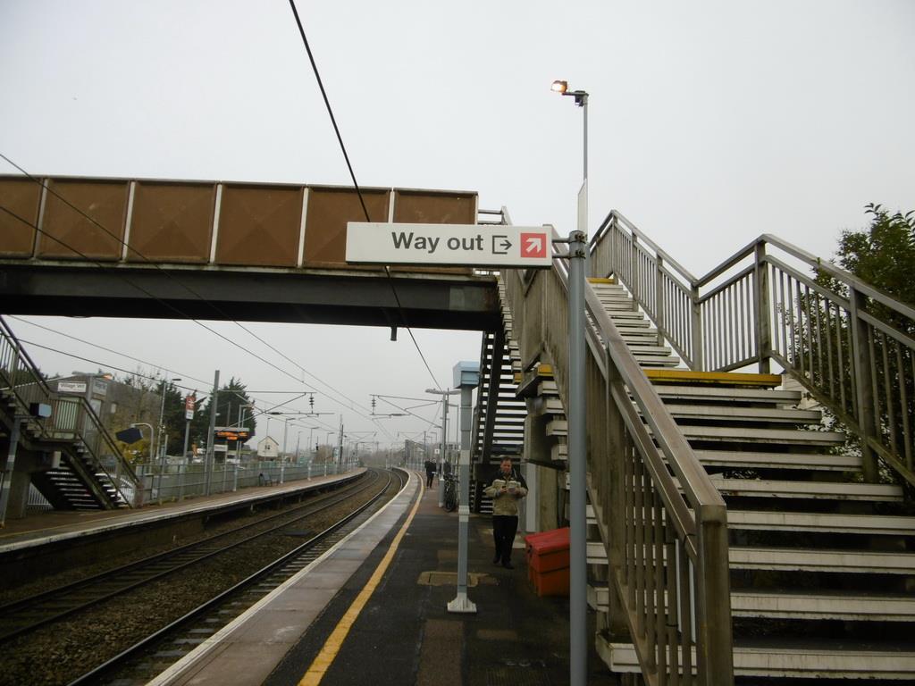 Picture 13(D): On the up side signs indicate the way out is via the bridge with no indication of the