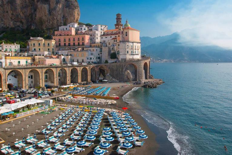 from your hotel in Sorrento and proceed to Pompeii, the worldfamous ancient town that lay buried under layers of volcanic ash for centuries, and that is considered a Unesco World Heritage Site, where