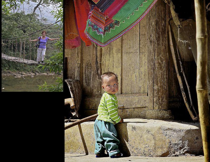 On the right, a little boy plays under his family s colourful washing in a