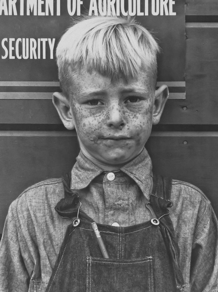 Migrant boy. Tulare migrant camp. Visalia, California March 1940 [Orphaned boys frequently walked the roads alone in search of work.