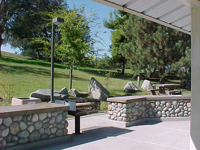 Photo P-5. Picnic shelter features, View 1. Millerton State Park, CA. Concrete pad extends beyond shelter for UA.