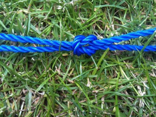 You should have three complete sides and one side where the two ends meet somewhere in the middle. Finish the open side using a reef knot. This is your hammock reinforcement rim.