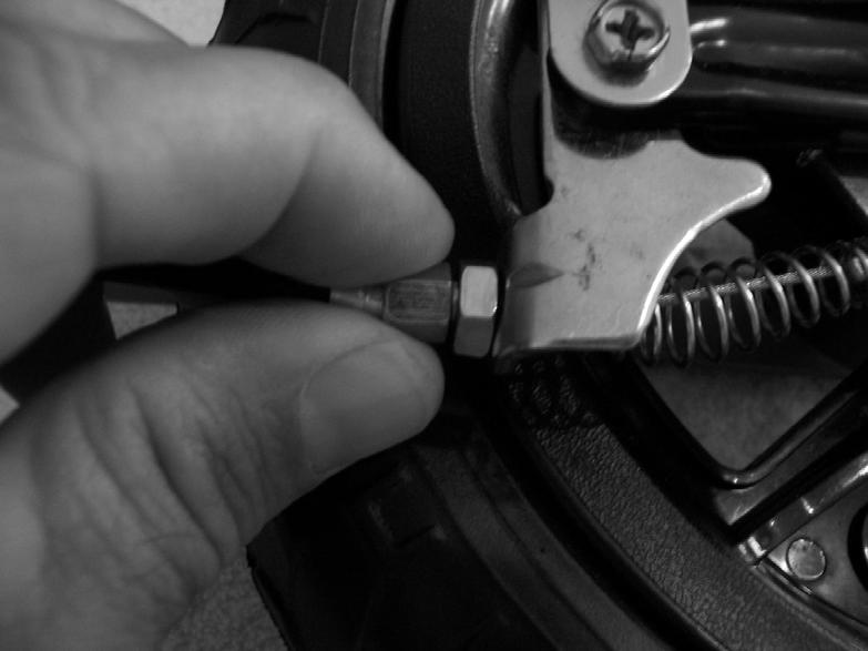 Once proper tension is set tighten the lock nut clockwise to prevent the barrel adjuster from moving. The wheel should spin freely but stop when lever is squeezed.