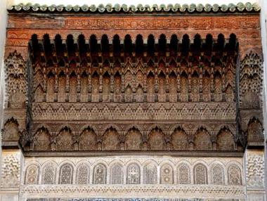 Gate to the Fez souk showing intricate wood and stone carving.
