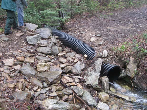 A well placed culvert draining both a direct flow and a ditch line. Never install two culverts side by side.