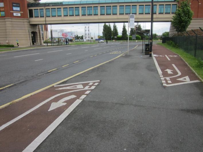 Traders Avenue forms a three-arm roundabout with Barton Dock Road. Traders Avenue provides two entry lanes onto the roundabout and two exit lanes.