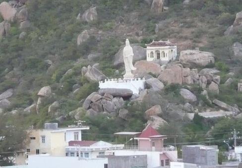 Pagodas, temples, and Catholic statues have been built into the rock