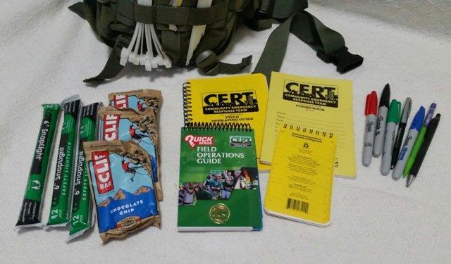 Next pocket down on the front of the pack, glow sticks, Cliff Bars, the CERT Field Guide, and various water-proof CERT booklets with forms and notepads to use for