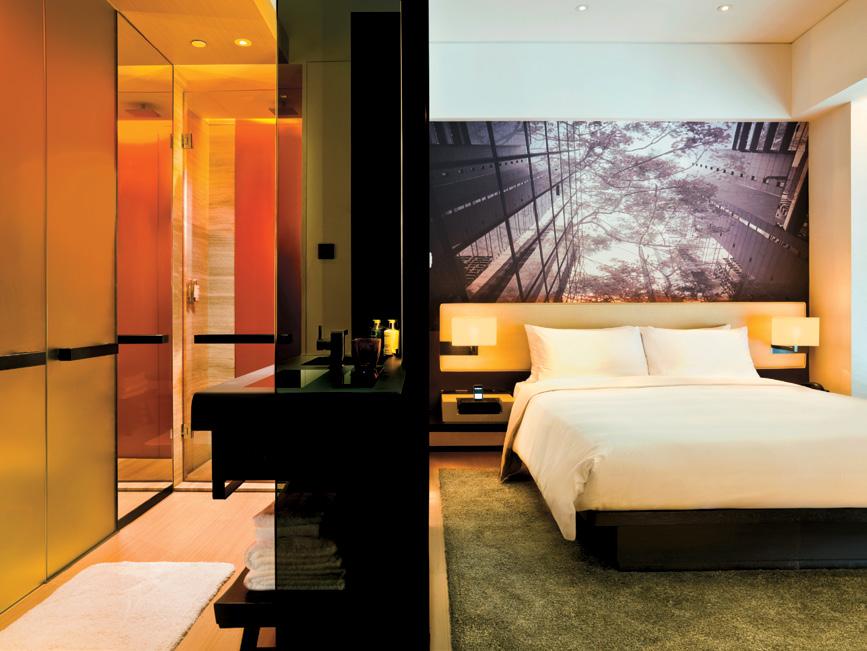 Innovative design, using glass screens to blend bedroom and bathroom together, gives guests a greater feeling of space.