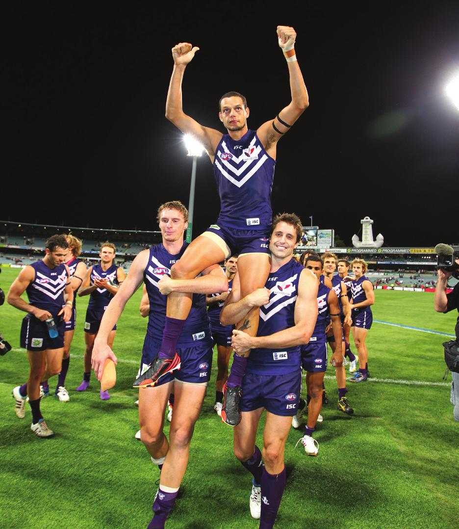 Fremantle s Michael Johnson is carried off the ground by teammates Jon