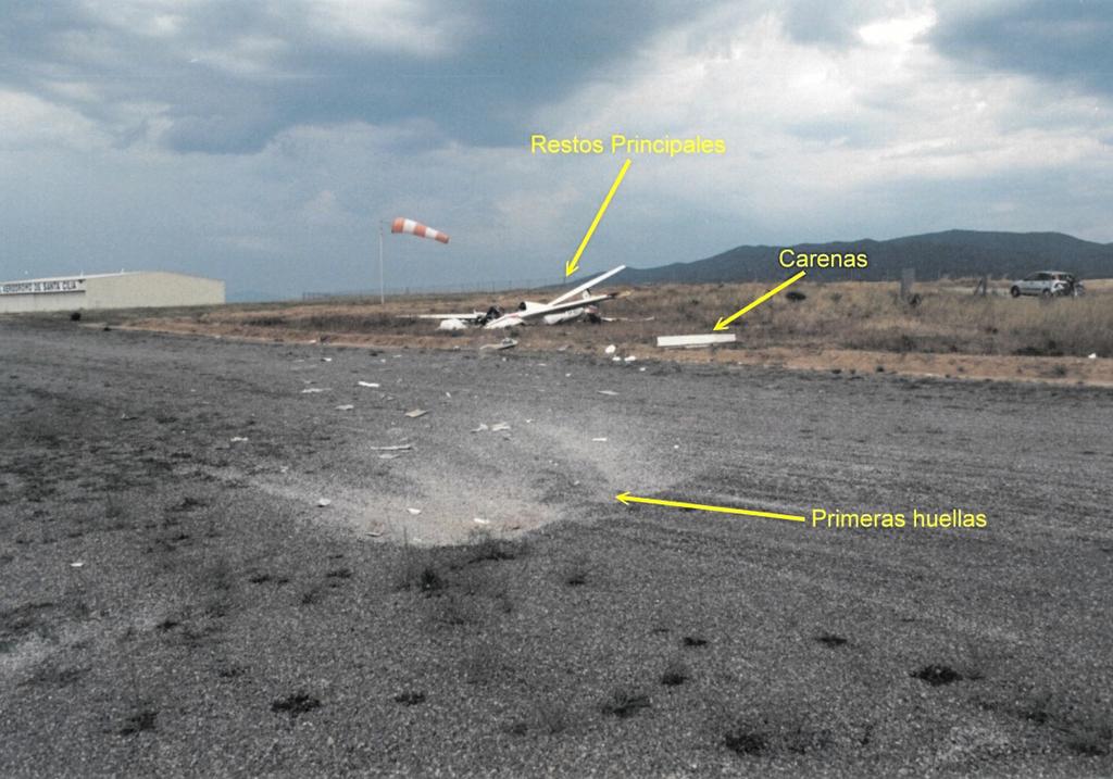 1.12. Wreckage and impact information The position and distribution of the wreckage, as it was found are shown in the photograph of Figure 2, which was taken looking forward in the direction of