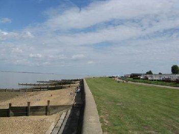 A concrete sea wall protects the Allhallows Leisure Park, which is in private ownership. A public footpath passes through the site adjacent to the sea wall.