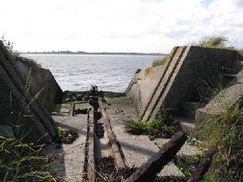 At the jetty, the footpath runs a short distance inland to pass underneath the gravel conveyor. It is bounded by fences and is currently too narrow for shared use.