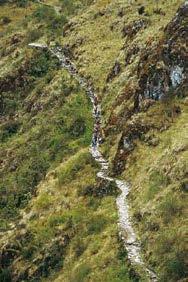 We begin our hike by crossing the bridge over the Urubamba River and walking along its left shore as it flows northwest along the Sacred Valley.