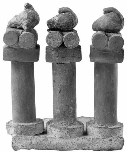 Originally, the two pillars were not associated with the figurine, probably because they were found in a different part of the building, and their restoration to the present day condition is due to V.