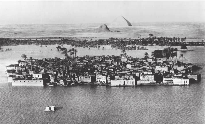 Figure 4. The inundation at Dahshur, with the village encircled by the fl ood and the pyramids in the background. Photo courtesy of Lehnert and Landrock.