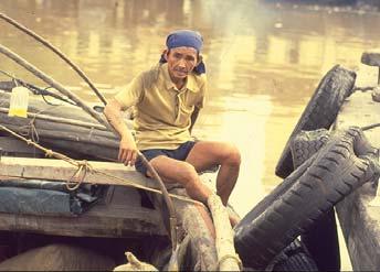 View of a lighter worker on his boat, with the muddy Singapore River in the background, 1983 Clarke Quay, which emerged as an important commercial centre in the late 19th century.
