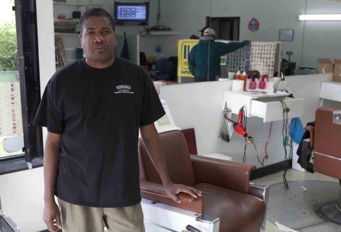 Irvelt Toussaint at his hair salon in Montreal. Toussaint sends money to relatives and friends in Haiti. hand with political, economic, and even military interference.