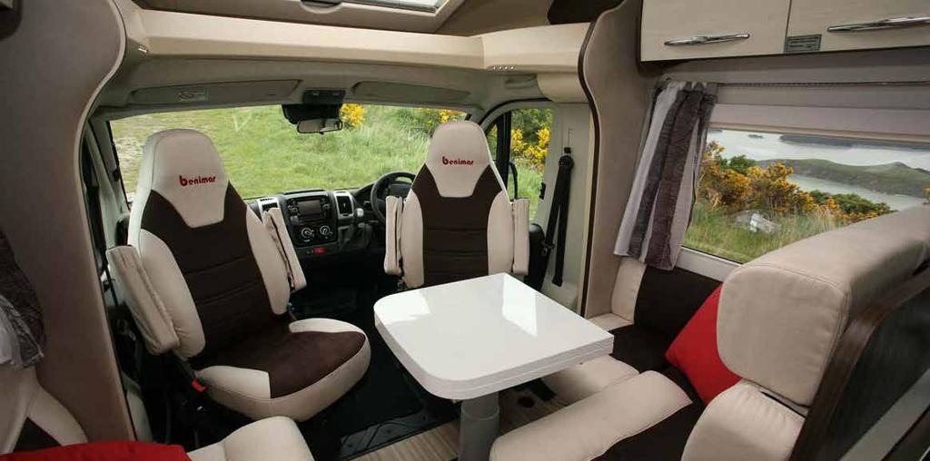 3 Day Test Right: The Truma Combi hot water and space heater is easily reached under the inwards-facing lounge seat. Below: Swivelled cab seats make the most of the cosy lounge/ dinette set-up.