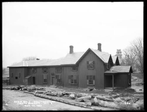 The boarding house is ready to be razed in 1897. The farm buildings beside and behind it have already been taken.