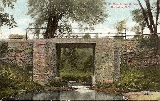 HOG BACK BRIDGE AKA SOUTH MAIN STREET BRIDGE In 1794 beginning at the old fording place, a road was laid out easterly and crossed at what is now Main Street, about where the Methodist Church stands