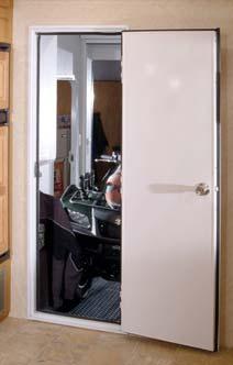 Enclosed cargo areas feature white laminated storage cabinets and durable, easy to clean vinyl wallboard