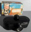 Lot # 138 - "Foto Reel", Viewer with roll of Black and white pictures and box. Small black oval shaped viewer with 25 black and white images of Exposition buildings.