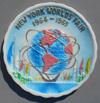 Lot # 360 - Multicolor Plastic Wall Plaque with serrated edges pictures Unisphere and flags. Marked "New York World's Fair" "1964-1965" on the front. Marked on back "Made in Hong Kong".