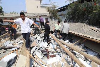 25 dead, 250 injured in China quake In this photo distributed by China's Xinhua news agency, Rescuers work at a collapsed building after a strong earthquake hit Yingjiang county in south-west China's