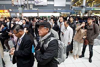 Millions stuck in Tokyo as subways shut Train passengers wait at Tokyo's Shinagawa station to get first-hand information on train service which was halted following a very strong earthquake.