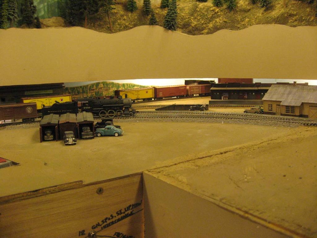 This unfinished scene shows the Spokane depot, freight house and team track on the right.