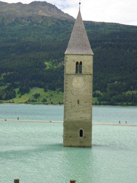 We pass the Reschen Reservoir where you will see only the church steeple that remains after villages of Graun and partly Reschen plus the ancient hamlets of Alrund, Piz, Gorf and