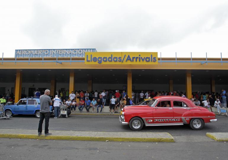 People wait for passengers to arrive at the airport in Havana. Reuters/St