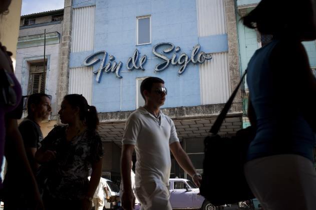 Pedestrians walk past Fin de Siglo, a department store dating back to pre-revolution Cuba, in Havana on Monday, Dec. 22, 2014. U.S. is moving to restore diplomatic relations with Cuba for the first time in more than a half-century.