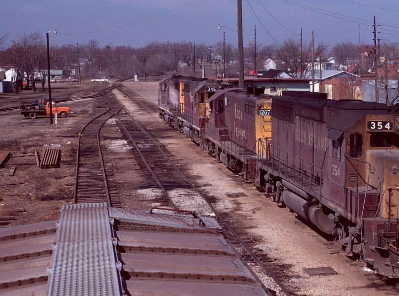 Left - As seen from the walkway of a GP40 on westbound #73, a crew change is taking place on train #74 at Eldon on March 15, 1975.