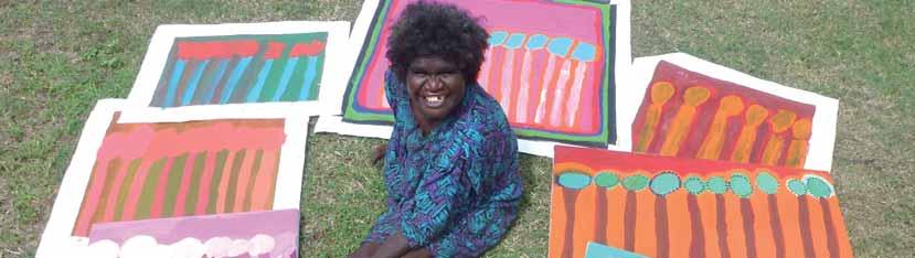 Fitzroy Crossing artist Lisa Uhl with her works. Photo provided by DADAA and Mangkaja Arts.